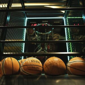 Basketballs lined up inside an arcade basketball game